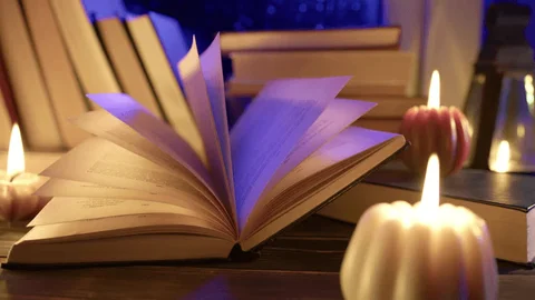 Evening candle and warm book reading